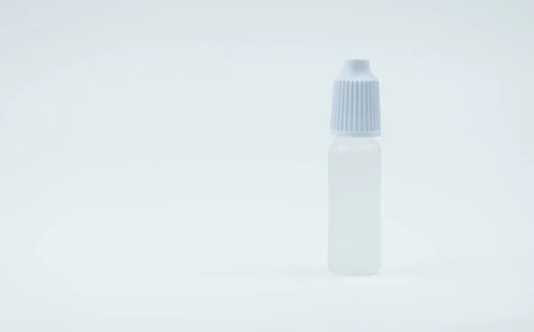 Eye drops bottle with white cap on white background with blank label and copy space, just add your own text. Dry eye disease from smartphone use, digital screen. digital eye strain. — Stock Photo, Image