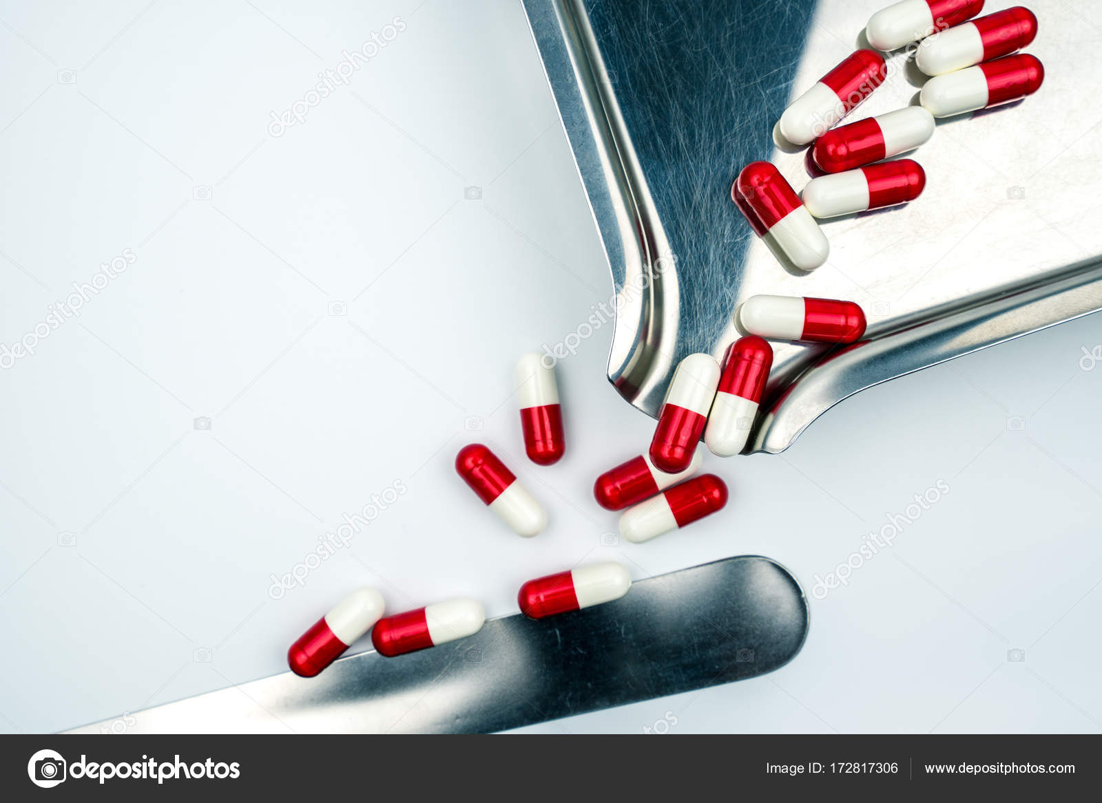 Red White Antibiotic Capsules Pills With Shadow On Stainless