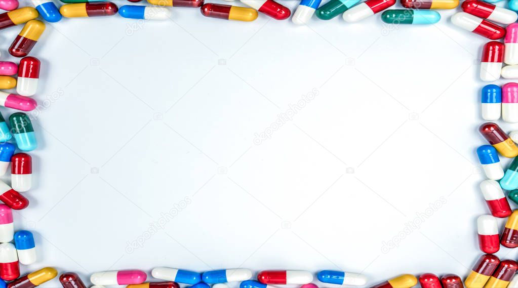 Colorful of antibiotics capsule pills rectangle frame on white background with copy space. Drug resistance concept. Antibiotics drug use with reasonable and global healthcare concept.