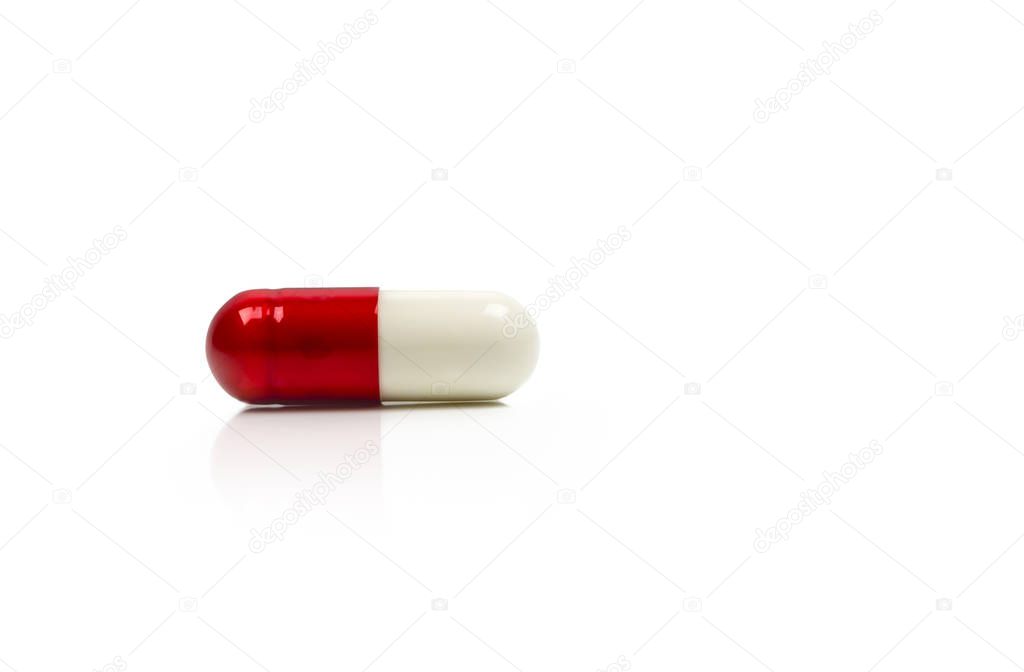 Red, white antibiotics capsule pill isolated on white background with copy space. Drug resistance concept. Antibiotics drug use with reasonable and global healthcare concept.