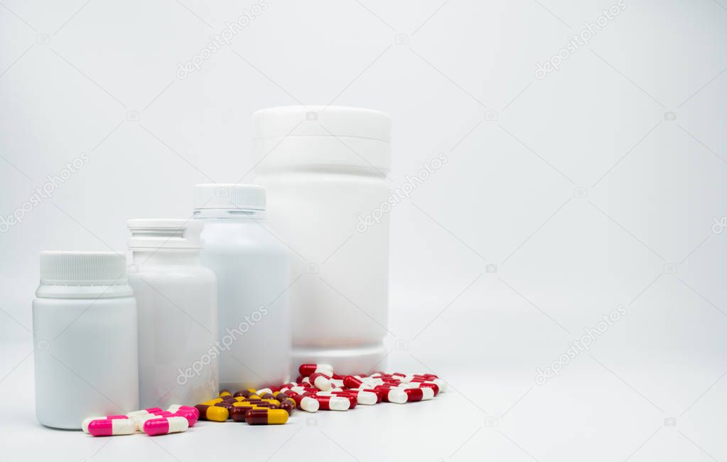 Antibiotic capsules pills and plastic bottle with blank label isolated on white background with copy space. Drug resistance concept. Antibiotics drug use with reasonable and global healthcare concept.