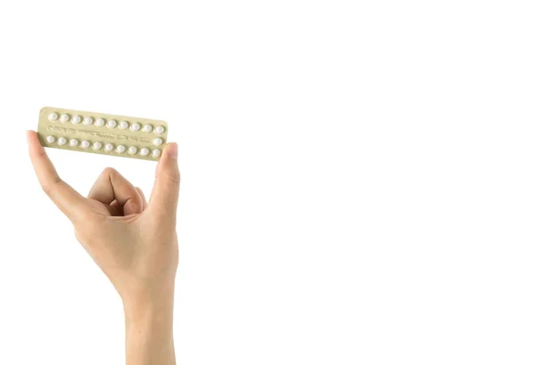 Asian young woman holding pack of contraceptive pills with one hand isolated on white background with copy space and clipping path. Choosing family planning with birth control pill concept — Stock Photo, Image