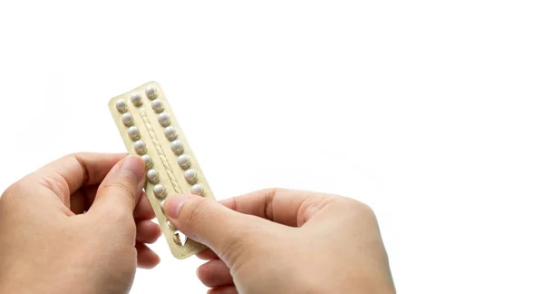 Woman hand taking birth control pills. Asian adult woman holding pack of contraceptive pills isolated on white background with clipping path. Choosing family planning with birth control pill concept — Stock Photo, Image