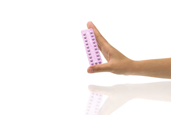 Asian young woman holding pack of contraceptive pills with one hand isolated on white background with copy space and clipping path. Choosing family planning with birth control pill concept. — Stock Photo, Image