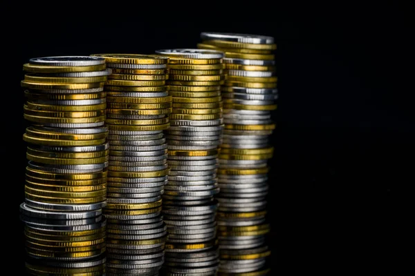 Macro shot detail of golden and silver color coin stacks on dark background with copy space for text. Business and finance growth, saving money, investment and interest concept. — Stock Photo, Image