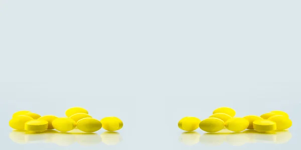 Gelbe ovale Tabletten mit Schatten auf weißem Hintergrund mit Kopierraum für Text. leichte bis mittelschwere Schmerzbehandlung. Schmerzmittel. — Stockfoto