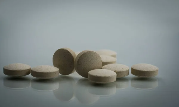 Macro shot detail of zinc amino acid chelate tablets pills on white background. Dietary supplement product for help sperm swim well. Vitamins, minerals and supplements for treatment male infertility.