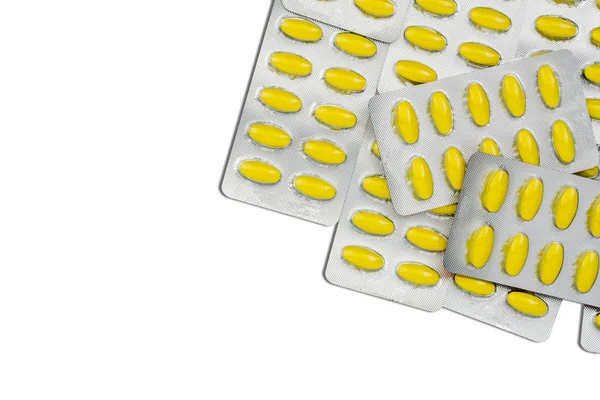 Вид сверху овальных желтых таблеток в блистерных упаковках. Желтые таблетки узор обои. Таблетки мефеномовой кислоты для снятия боли, спазмов, головной боли и зубной боли . — стоковое фото
