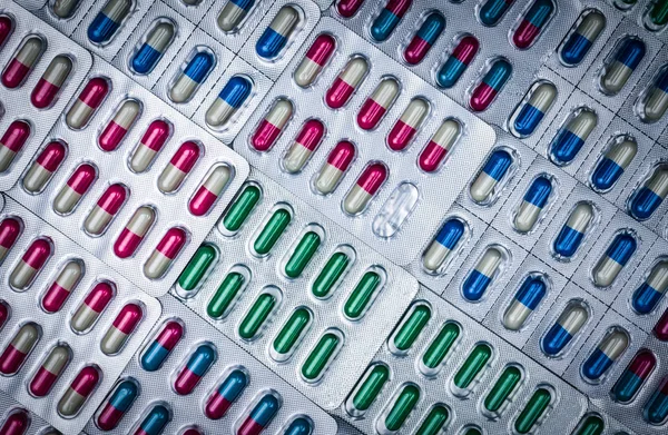 Full frame of colorful antimicrobial capsule pills. Quality cont — Stock Photo, Image