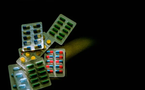 Coloré de capsules antibiotiques en plaquette thermoformée sur fond sombre avec espace de copie. Médecine pour les infections maladie. Utilisation d'antibiotiques avec raisonnable. Résistance aux médicaments et concept de santé . — Photo