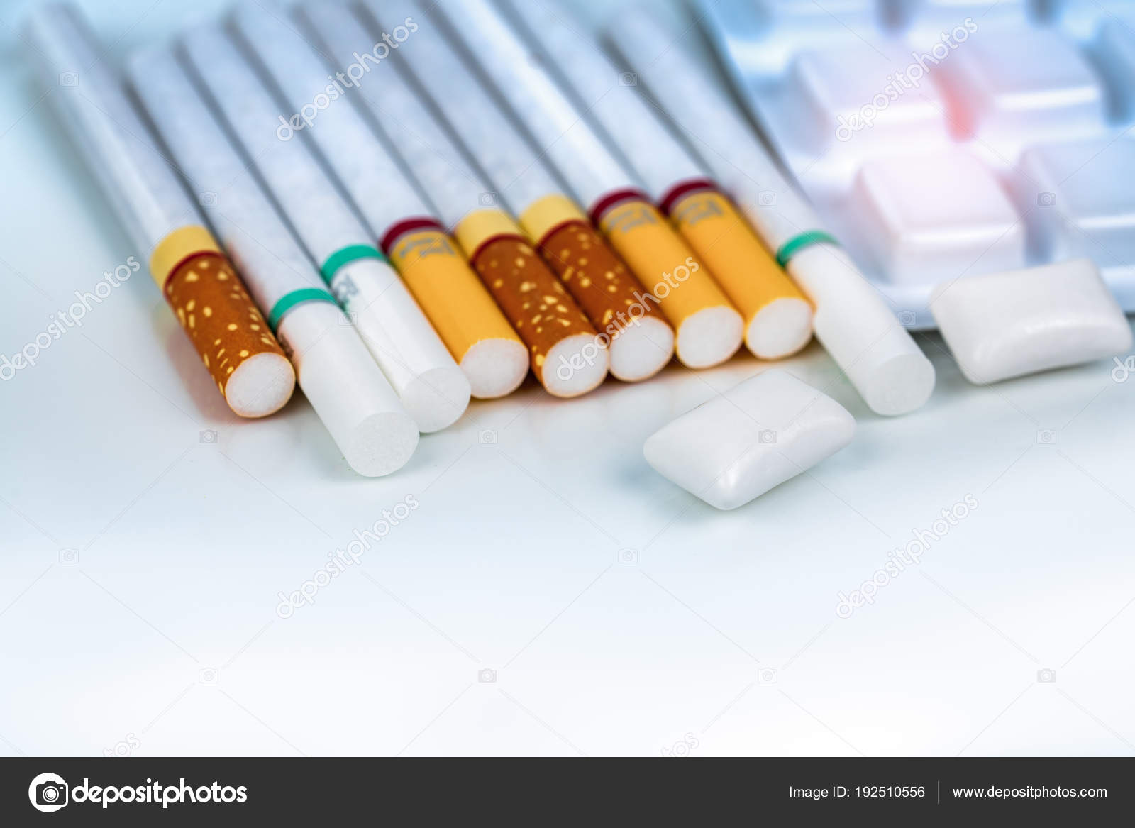 Nicotine chewing gum in blister pack near pile of cigarette. Quit smoking by use nicotine gum