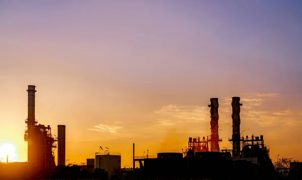 Gas turbine electrical power plant. Energy for support factory in industrial estate. Natural gas tank. Small gas power plant. Power plant using natural gas for fuel. Green energy. Dramatic sunset sky.