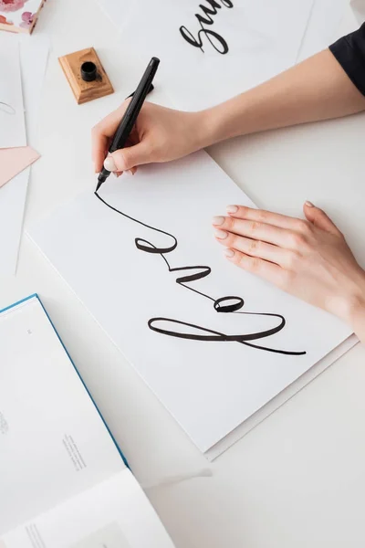 Close up photo of young woman hands writing cute notes on paper on desk isolated — Stock Photo, Image