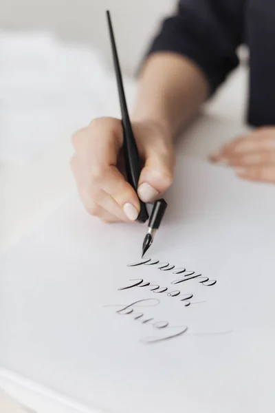Close up photo of woman hands holding classic ink pen and writing beautiful postcard isolated — Stock Photo, Image