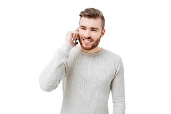 Cheerful young man talking on the phone isolated — Stock Photo, Image