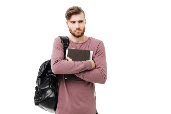 Estudiante trastornado con libros llevando una mochila aislada — Foto de Stock