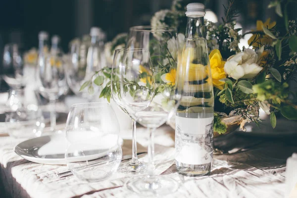 Beautiful festive table setting, closeup. Wedding festive interior, table decorations, flowers, table setting, wine glass, pastel summer tones