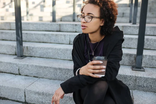 Pensive Africký Žena Nošení Brýle Pití Vzít Kávu Sedí Ulici — Stock fotografie