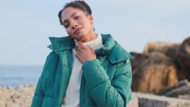 Güzel, şık, Afro-Amerikan kızı rüyasında deniz kenarında poz veriyor.