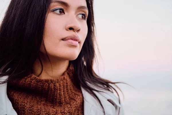 Portrait of atraktive Asian girl thoughtfully looking away outdoor — Stok Foto
