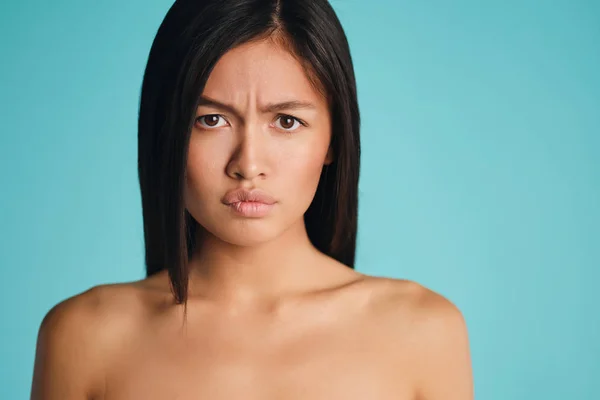 Retrato de chica morena asiática molesta mirando ofensivamente en la cámara sobre fondo colorido — Foto de Stock