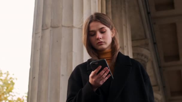 Menina Elegante Bonita Casaco Usando Atentamente Celular Caminhando Pensativamente Através — Vídeo de Stock