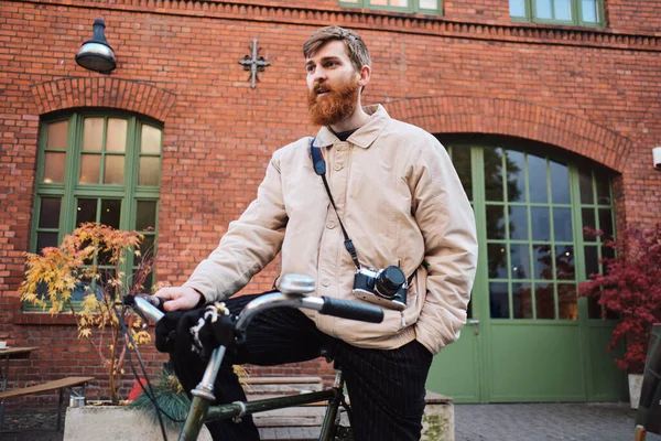 Young attractive bearded man standing with old classic bicycle on city street — 스톡 사진