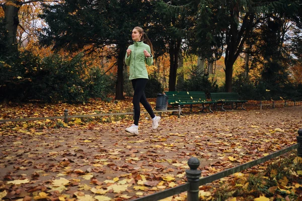 Atrakcyjna sportowa dziewczyna marzy o bieganiu po pięknym jesiennym parku — Zdjęcie stockowe
