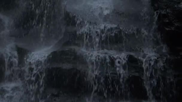 Tracking up shot of beautiful water fall on tropical island at dusk