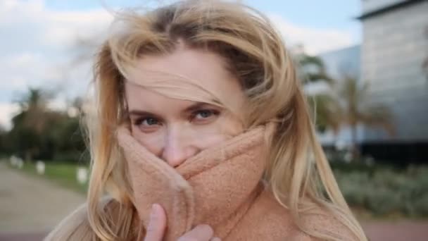 Close Shot Charming Blond Girl Covering Face Coat Happily Posing — Stock Video