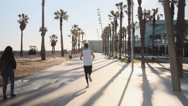 Conceptual Shot Young Sporty Man Running Morning Seaside Palms Barcelona — Stock Video