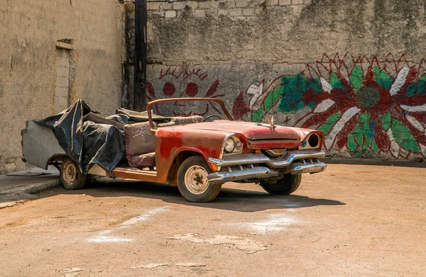 Abandoned 1950s-era car in alley with graffiti in Havana — Stock Photo, Image