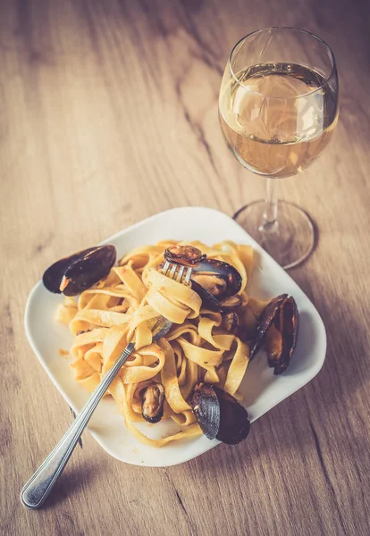 Italian tagliatelle with sea food on vintage wooden background — Stock Photo, Image