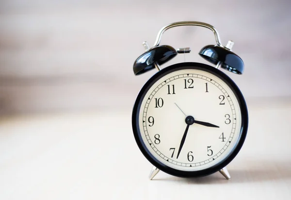 Vintage background with retro alarm clock on table — Stock Photo, Image