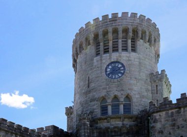 Public clock on old stone tower
