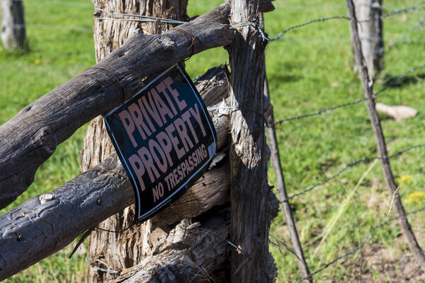 No trespassing sing on wooden fence