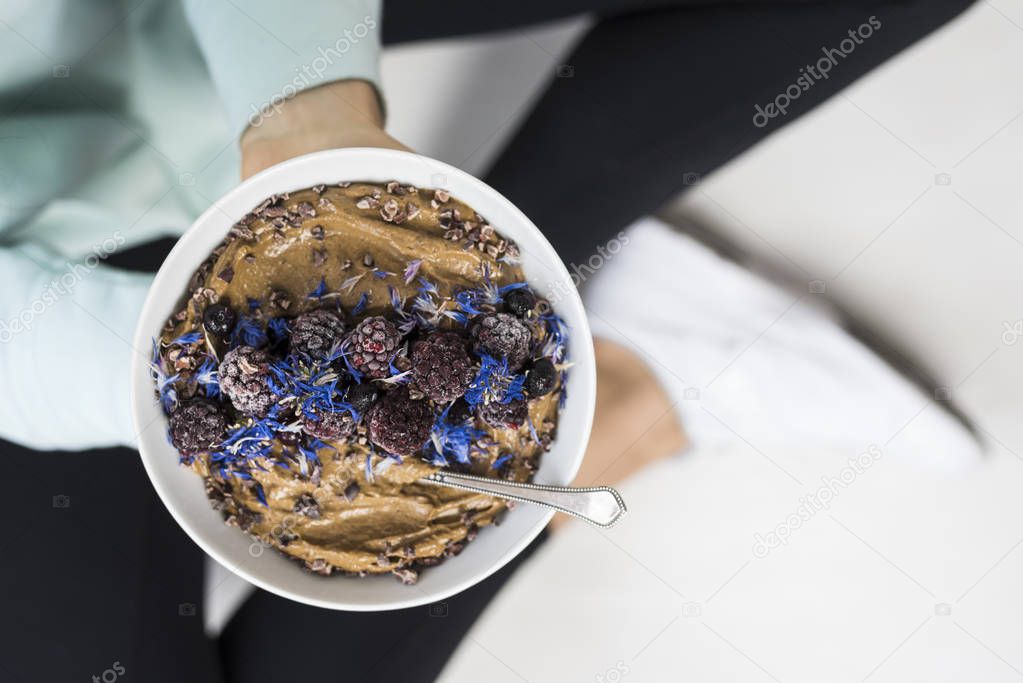 Woman holding smoothie bowl