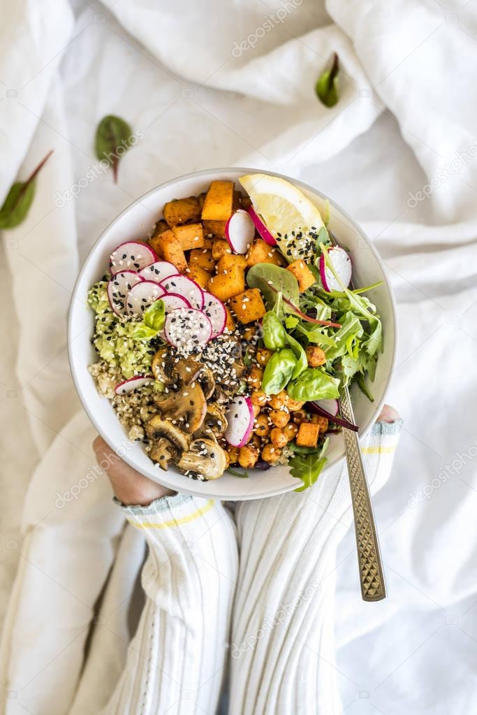 Woman holding vegan buddha bowl