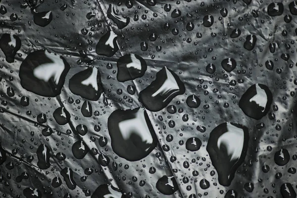Water drops on black plastic bag — Stock Photo, Image