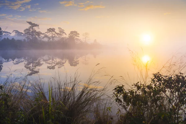Rayons de lever de soleil sur le lac avec brume réfléchissante sur l'eau , — Photo