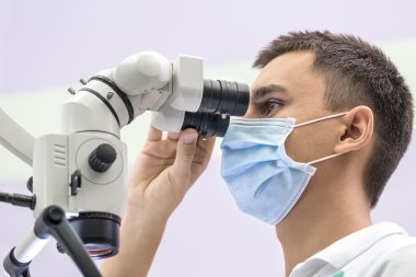 Doktor diş bir mikroskop kullanarak