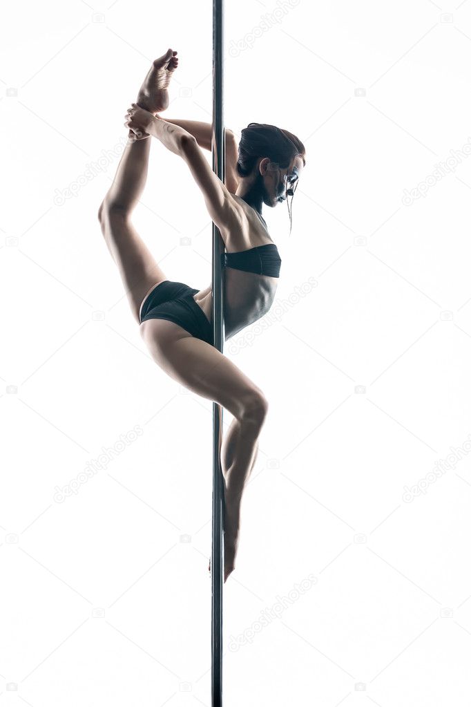 Female pole dancer with body-art on pylon