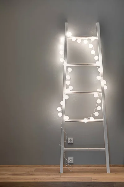Ladder with glowing garland — Stock Photo, Image