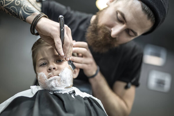 Humorous shaving of little boy