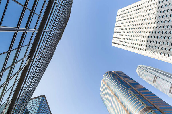 Several skyscrapers on the blue sky background in Singapore. View from below. Horizontal.