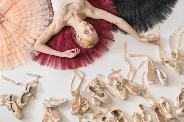Blonde ballerina lies in studio — Stock Photo, Image