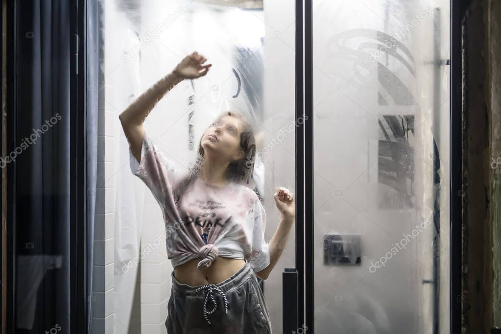 Woman is drawing on glass door