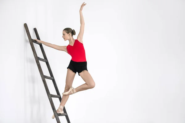 Ballerina on ladder in studio — Stock Photo, Image