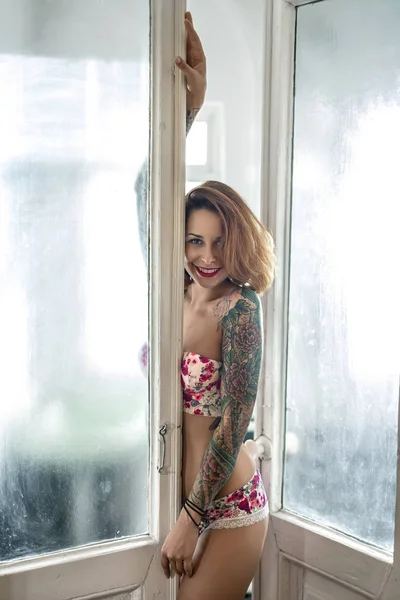 Tattooed girl posing indoors — Stock Photo, Image