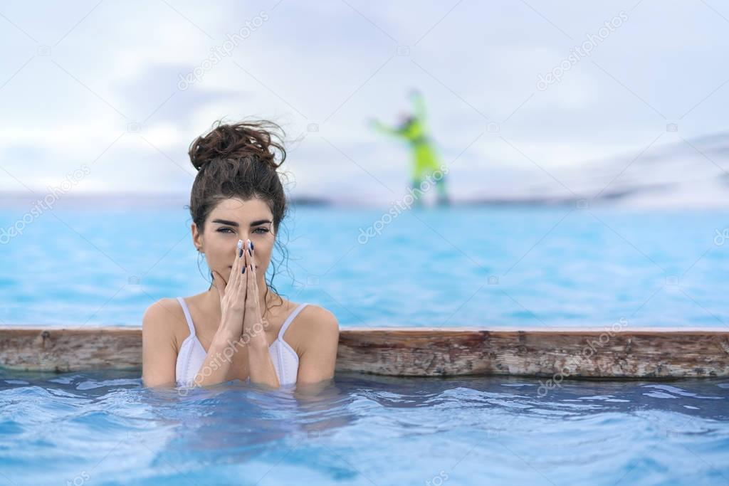 Girl relaxing in geothermal pool outdoors